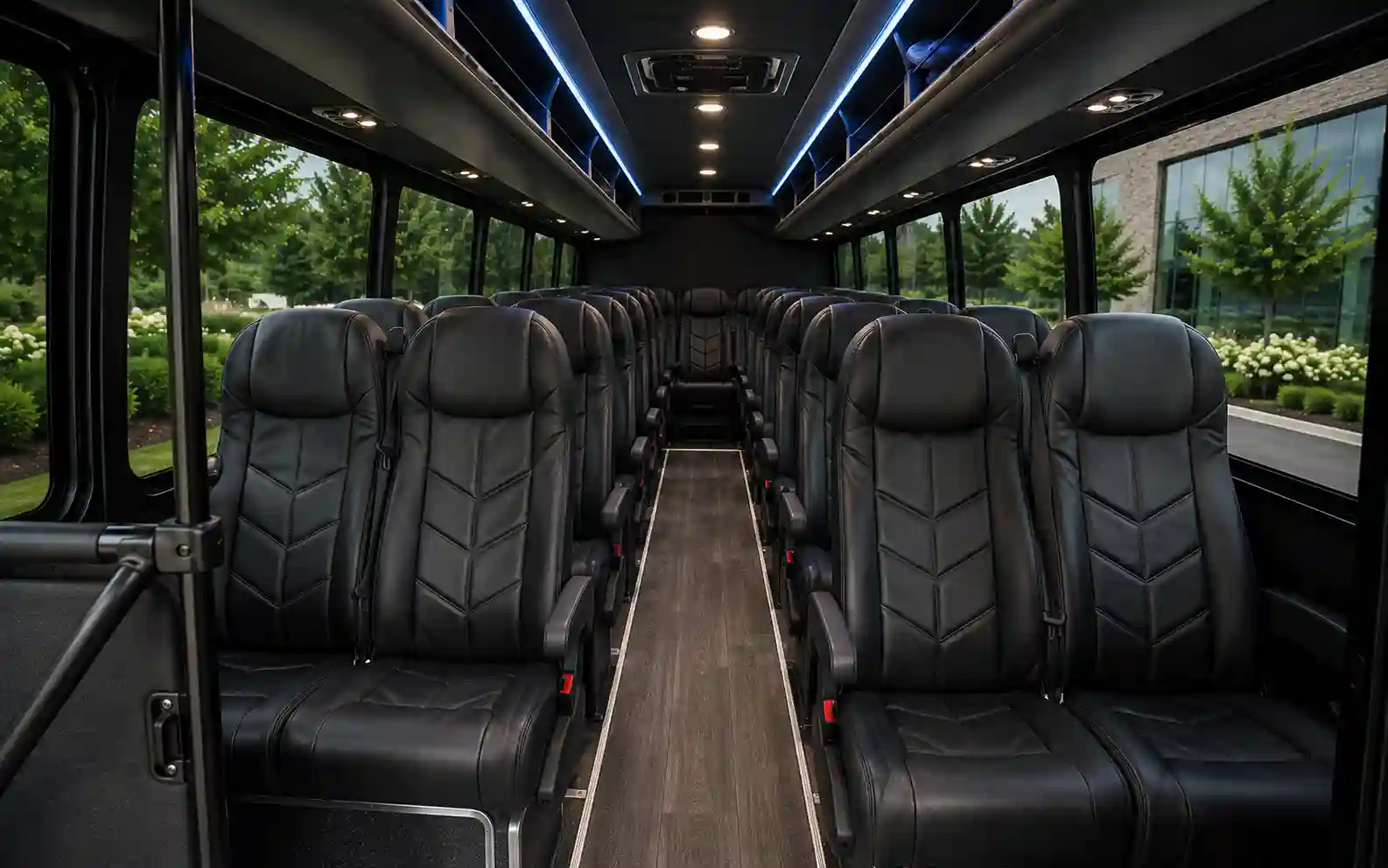 Forward-facing seats and overhead racks inside a 28-passenger executive mini bus
